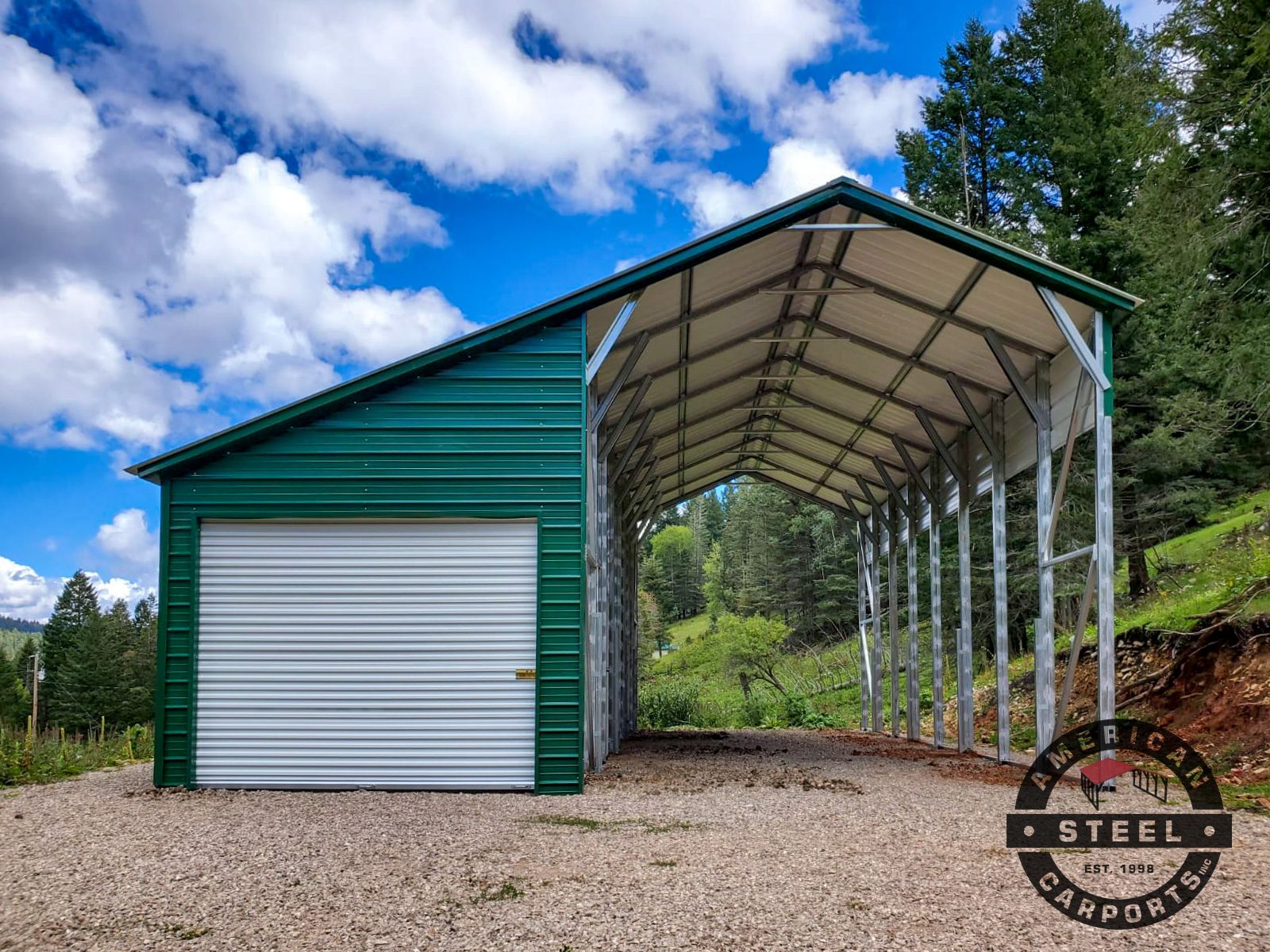 Steel carport with enclosed storage room, green roof, forest backdrop