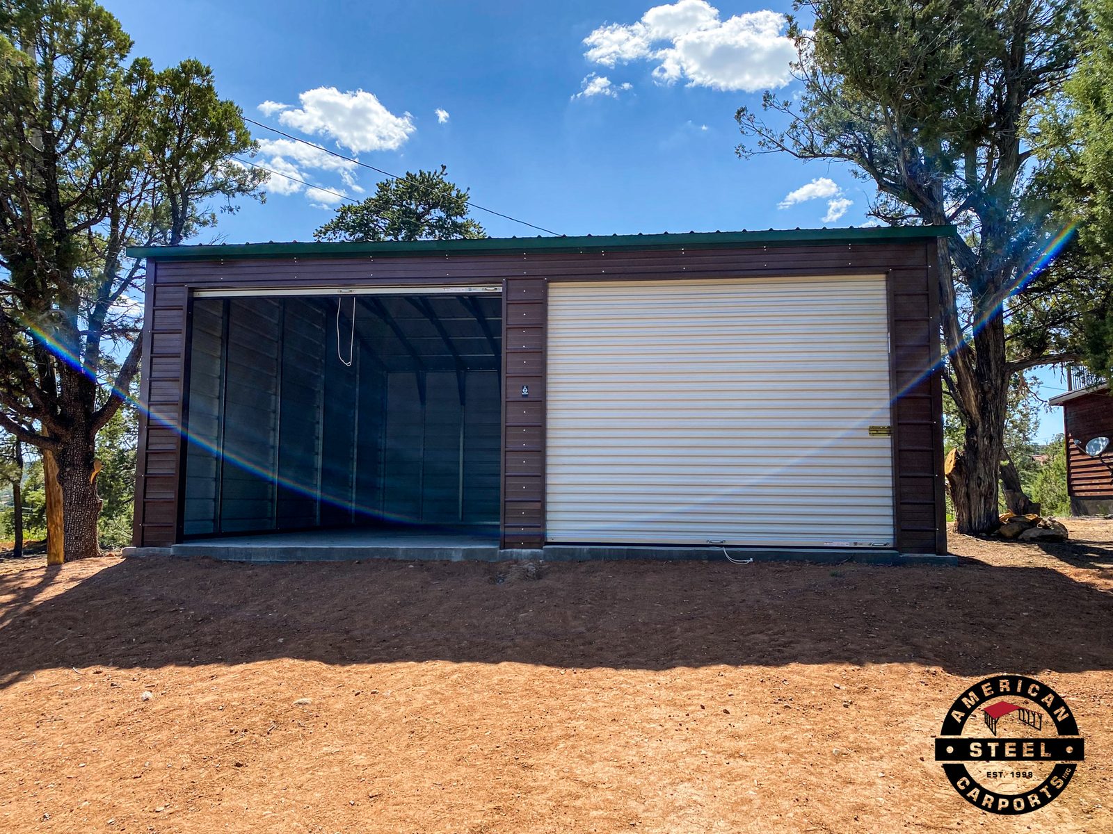 Brown steel garage with green roof and white roll-up door