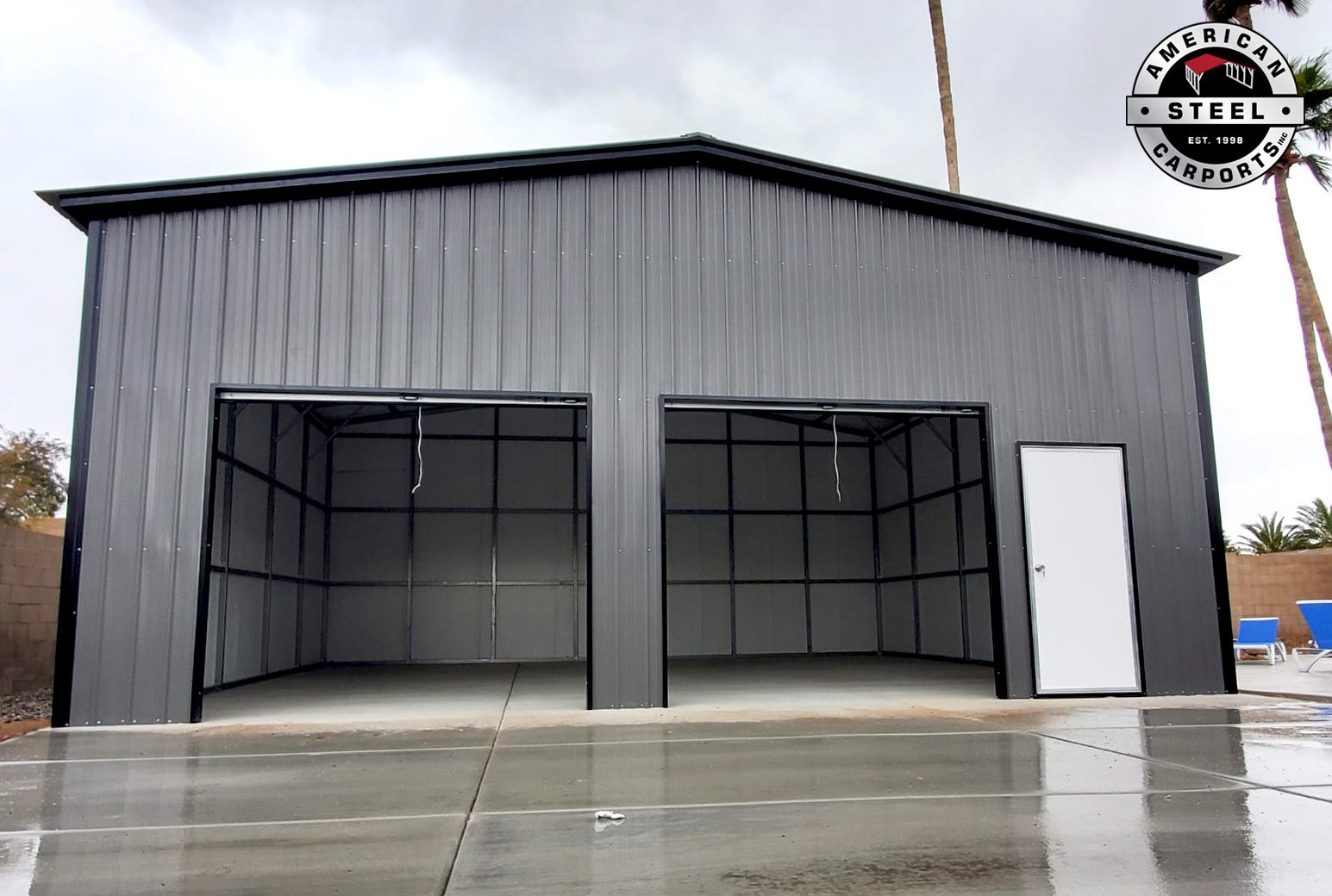 Charcoal steel garage with two open bays and walk-in door