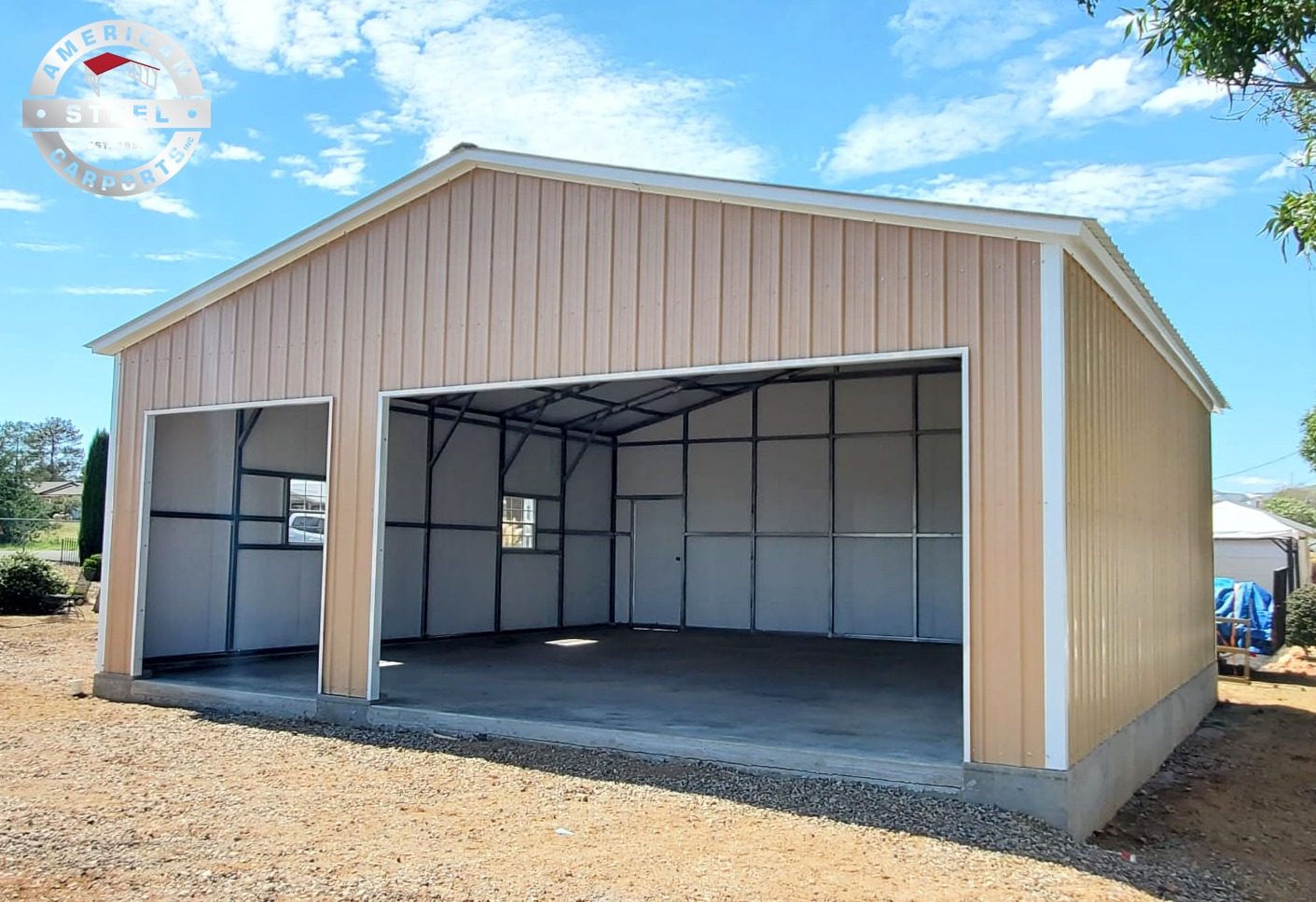 Tan steel garage with wide open bays on concrete slab