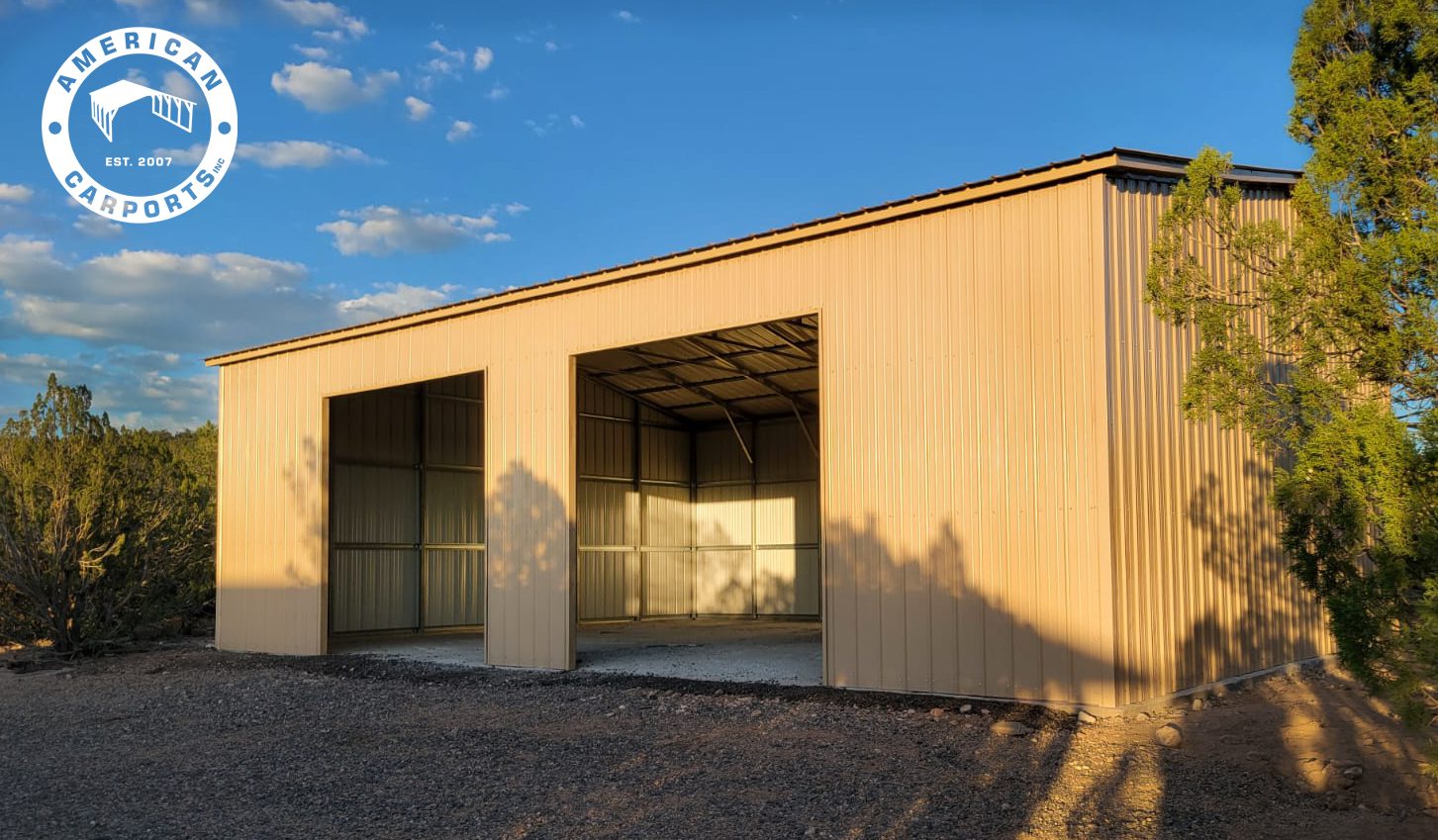 Tan two-car steel garage with twin roll-up doors in evening light