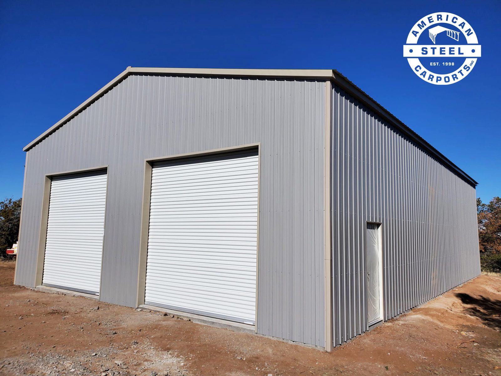 Silver steel workshop with two large roll-up doors